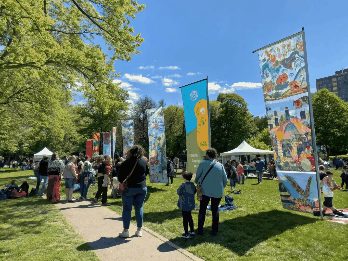 A photo of a community event showcasing art installations made from recovered scenographic materials, highlighting the impact of ARTSTOCK's educational and cultural initiatives.